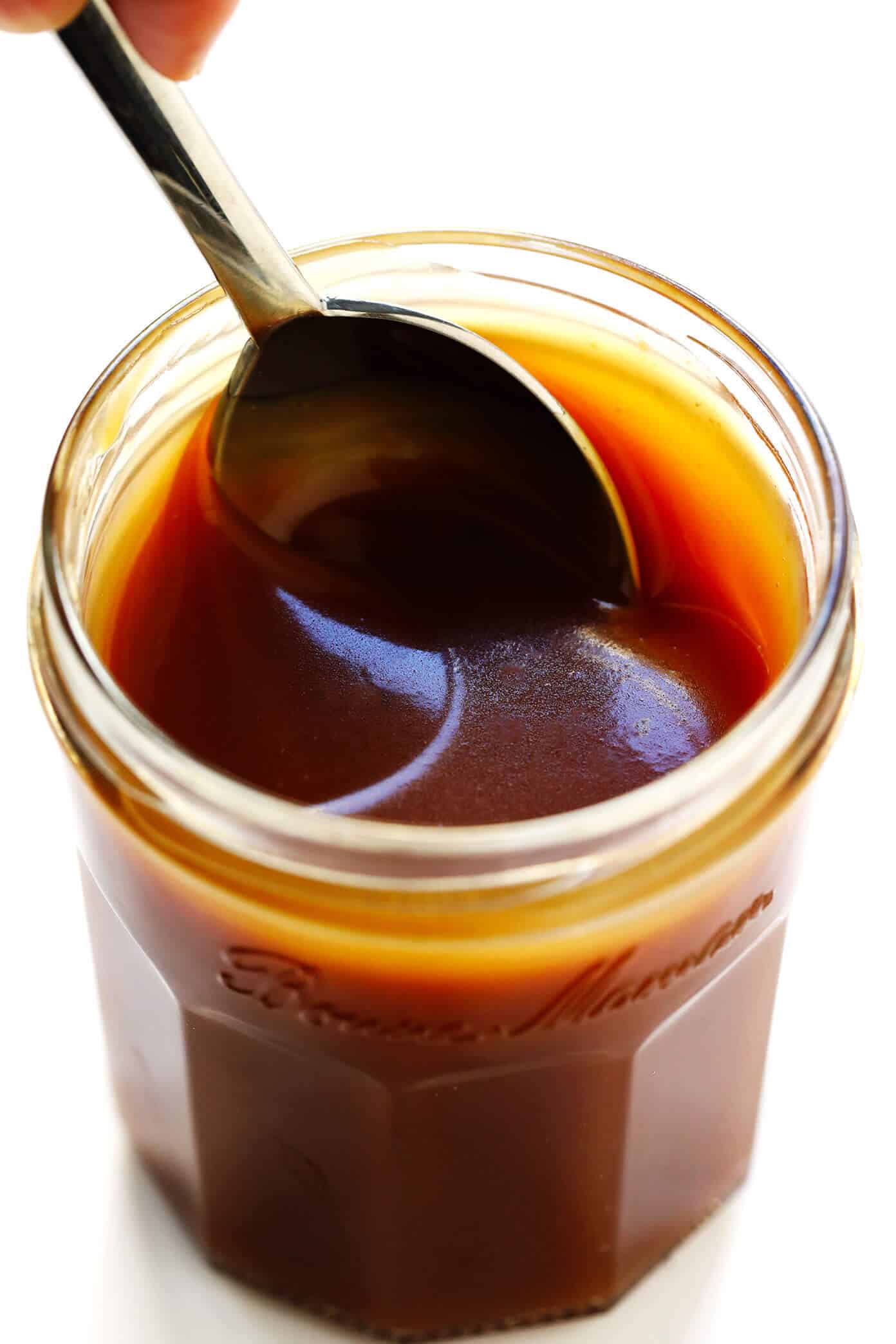 This 10-Minute Bourbon Caramel Sauce recipe is easy to make and crazy delicious. Drizzle it on everything from ice cream to fruit, brownies, cheesecake, pies, coffee drinks, and more! | gimmesomeoven.com #caramel #sauce #dessert #topping #glutenfree #summer Bourbon Caramel Sauce Recipe