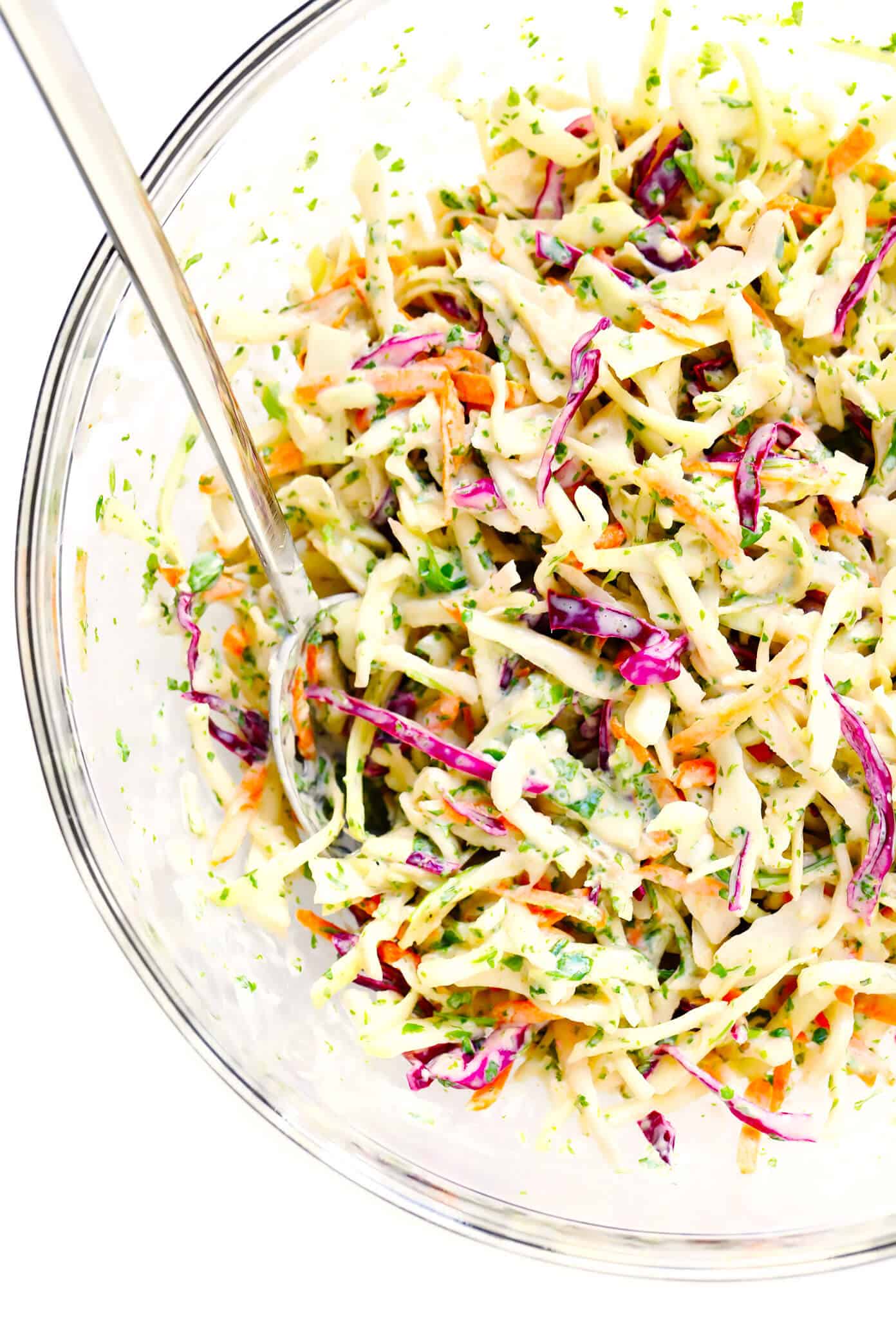 This Cilantro Lime Slaw recipe is easy to make in just 10 minutes, it tastes extra fresh and light, and it can work great as a zesty side dish or as a topping for fish tacos, burgers, sandwiches and more. Definitely a fresh and healthy slaw recipe to keep in your back pocket! | gimmesomeoven.com #coleslaw #slaw #healthy #mexican #vegetarian #salad #makeahead #side Cilantro Lime Slaw Recipe