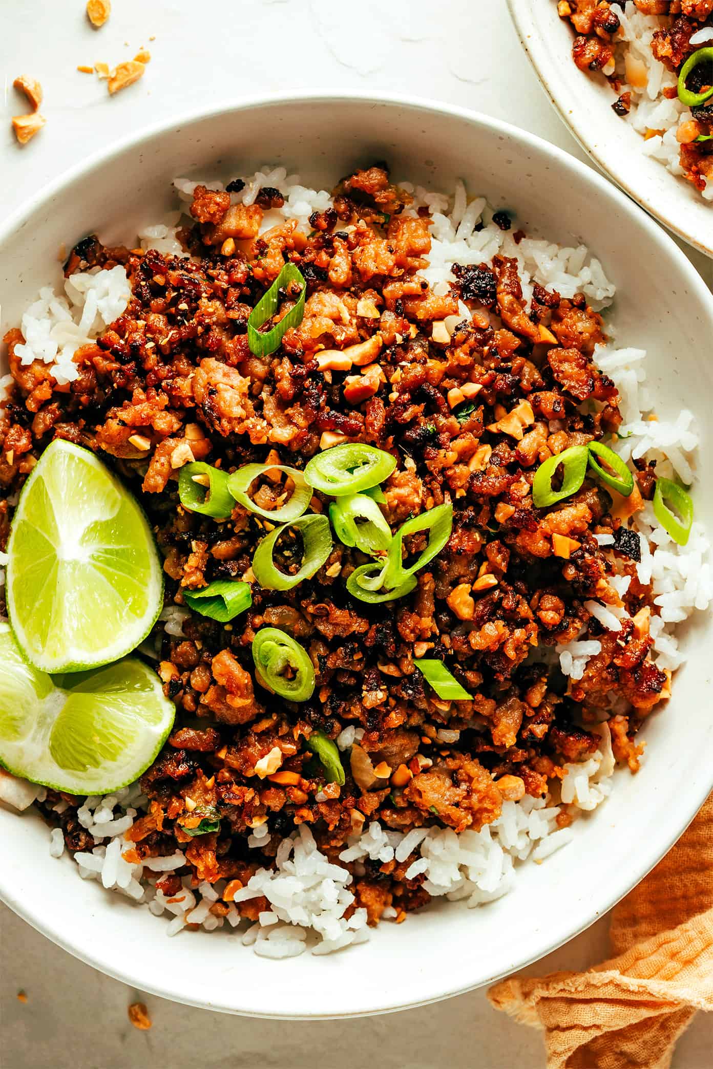 This Ginger Lime Pork with Coconut Rice recipe comes together in just 30 minutes and is bursting with sweet and savory flavors. It's also naturally gluten-free, easily adaptable with chicken, beef, turkey or seitan, and always makes for a delicious quick dinner. | gimmesomeoven.com Ginger Lime Pork with Coconut Rice in Bowls with Lime