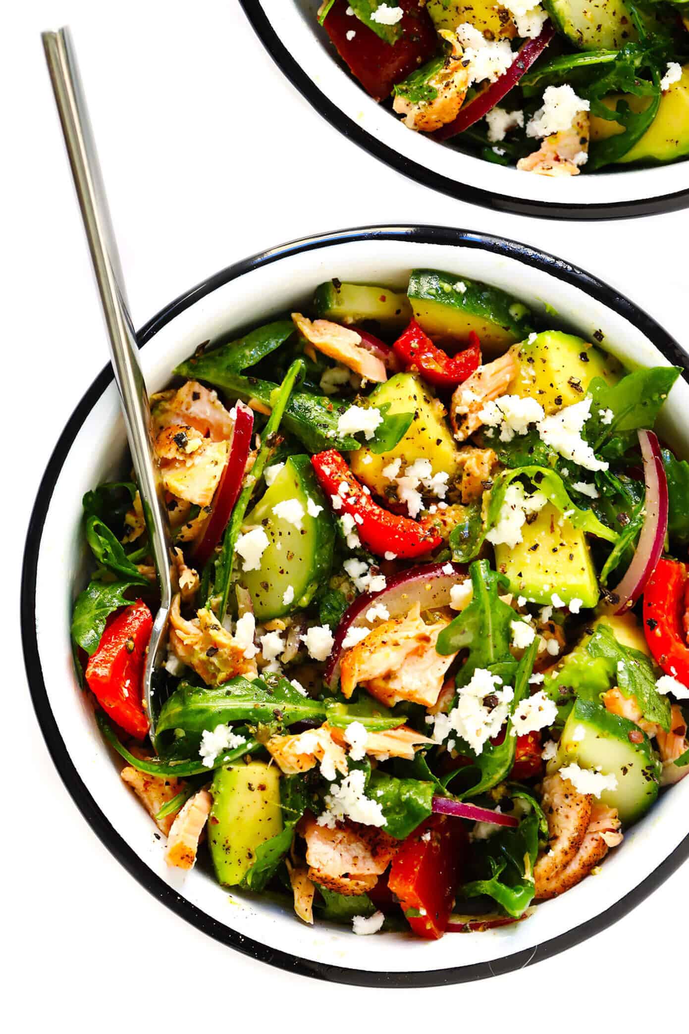 These Greek Salmon Salad Bowls are loaded up with cucumber, bell pepper, onion, avocado, feta cheese, arugula, and tossed with a simple red wine vinaigrette. Easy to make in 20 minutes, and SO delicious! | gimmesomeoven.com #greek #salad #healthy #dinner #salmon #mealprep Greek Salmon Salad Bowls