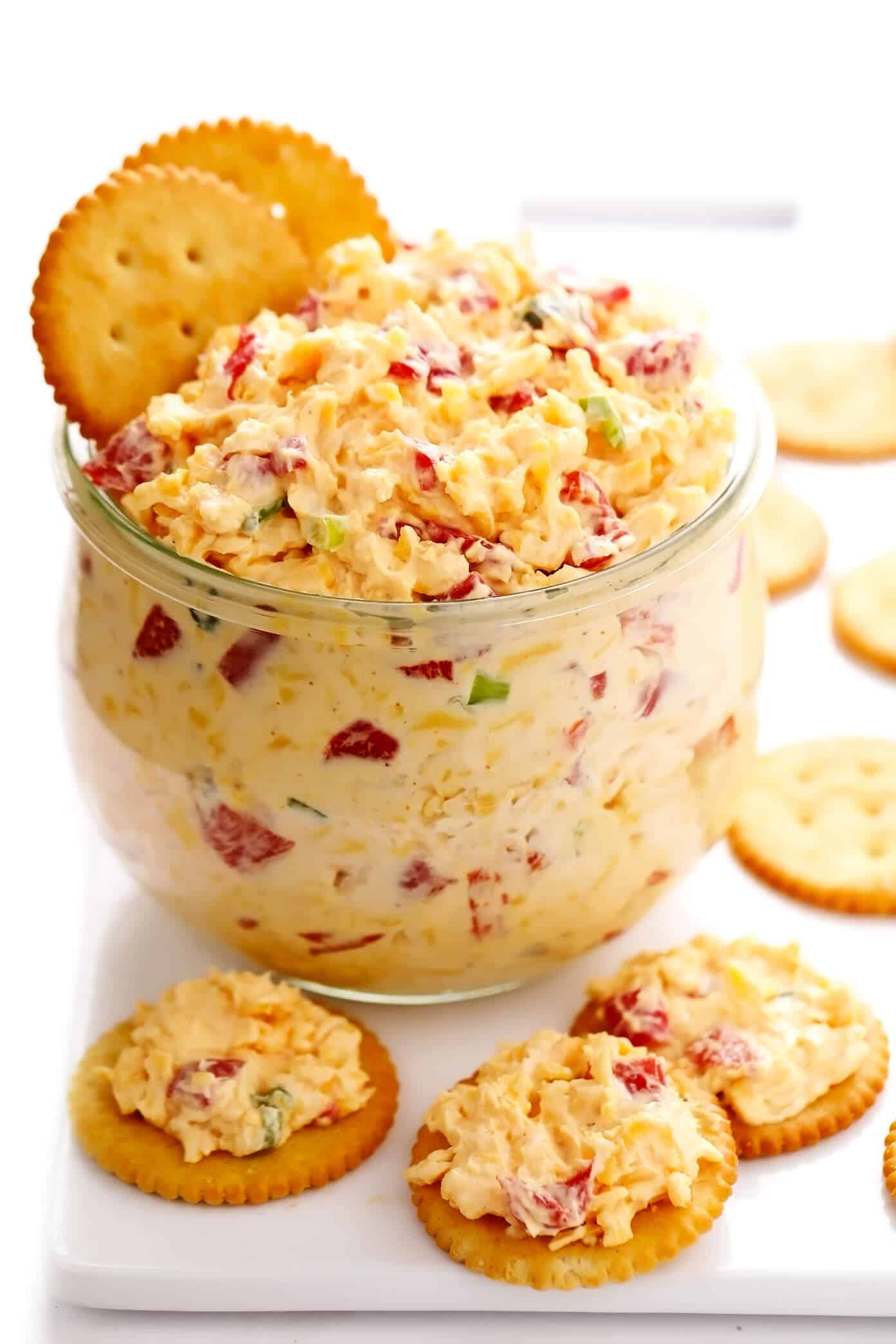 This 10-minute homemade pimento cheese recipe is made with sharp cheddar, tangy cream cheese and mayo, roasted red peppers, fresh green onions, and a zesty blend of seasonings. Serve it as a appetizer dip or spread on sandwiches, burgers, veggies, or whatever sounds good. | gimmesomeoven.com #pimento #pepper #cheese #dip #spread #glutenfree #southern #sandwich Homemade Pimento Cheese with Ritz Crackers