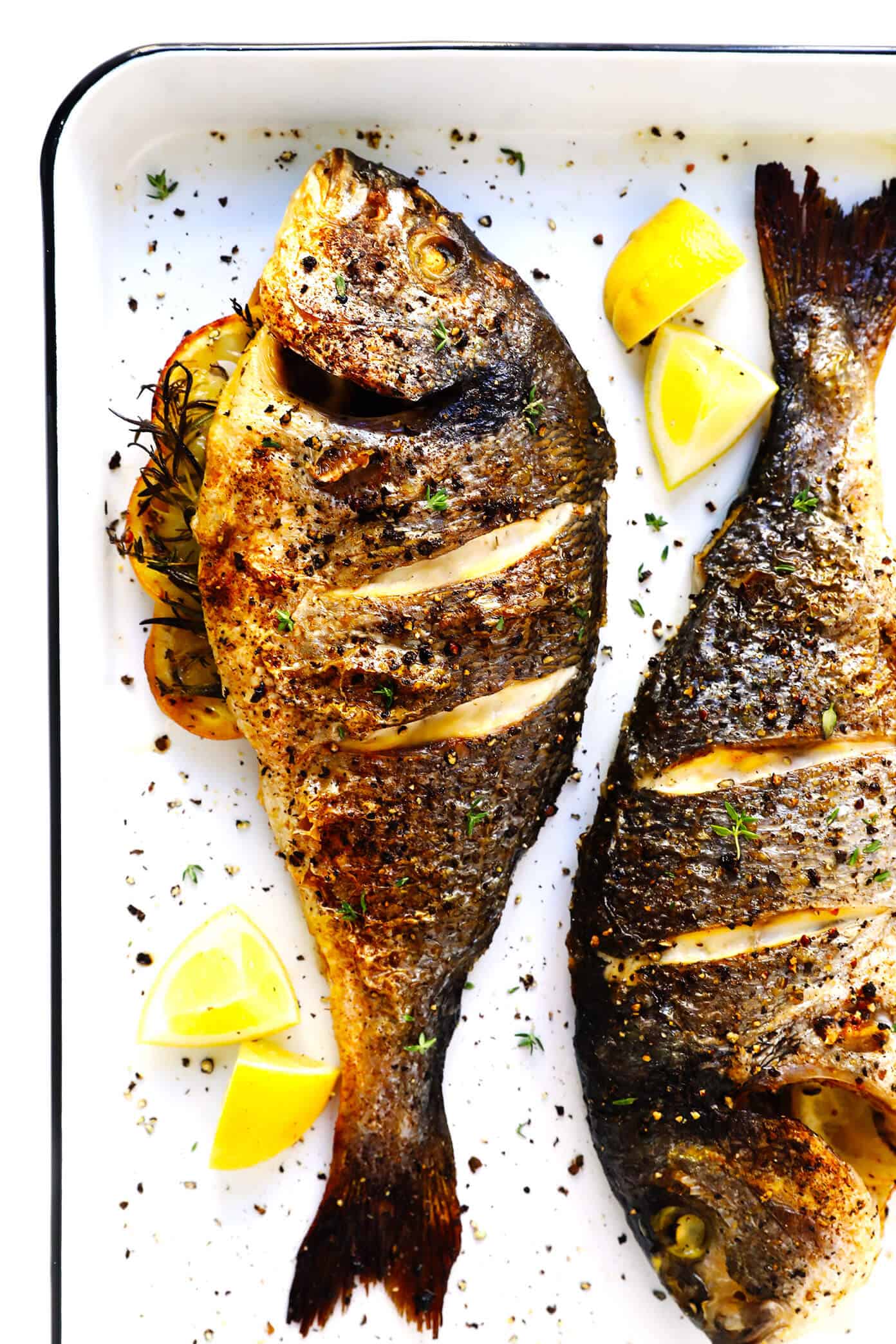 Learn how to cook a whole fish in the oven with this easy step-by-step tutorial and recipe! It's easy to make with mahi mahi, sea bass, branzino, red snapper, or whatever your favorite fish may be, and seasoned with a simple blend of lemon, garlic and herbs. The perfect healthy dinner! | Gimme Some Oven #fish #dinner #healthy #recipe #mahimahi #seabass #glutenfree How To Cook Whole Fish In The Oven