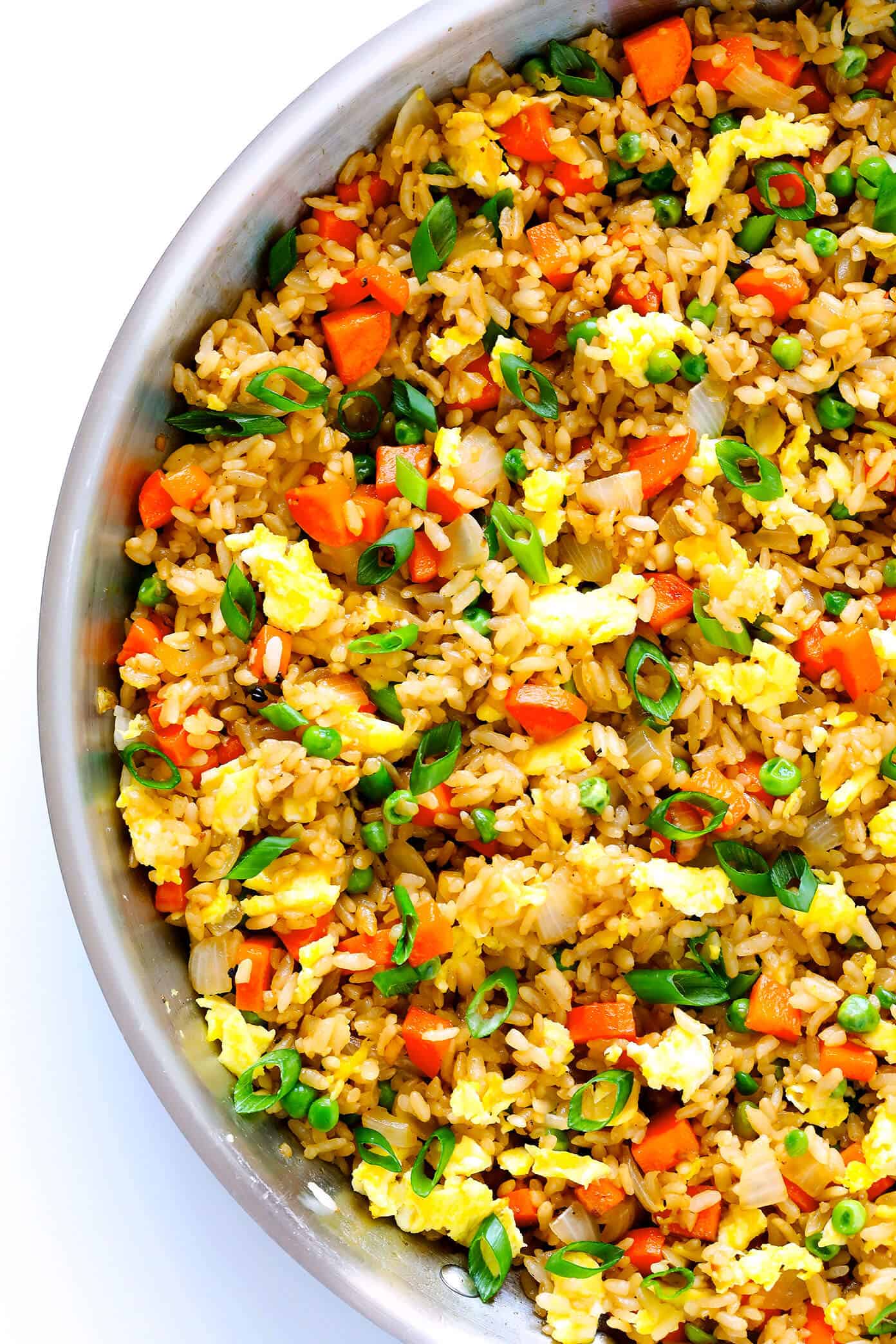 The BEST homemade fried rice recipe!! It only takes 15 minutes to make, it's easy to customize with your favorite add-ins (like chicken, pork, beef, shrimp, tofu, and/or vegetables), and it is SO flavorful and delicious! Way better than any Chinese takeout I've ever tried. ;) | gimmesomeoven.com #rice #friedrice #chinese #dinner #takeout #vegetarian #asian #easy Homemade Fried Rice Recipe