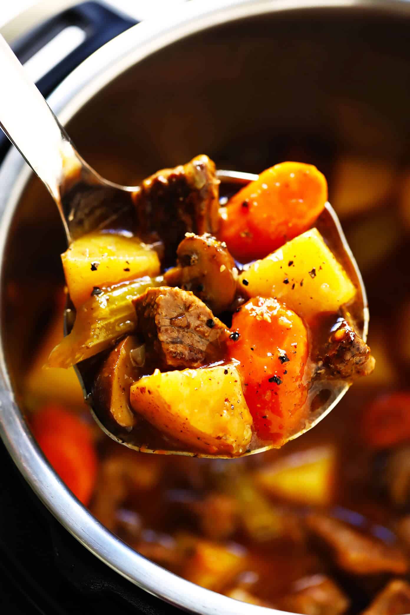 My favorite classic Beef Stew recipe -- full of tender steak, hearty potatoes, carrots, celery, onions, mushrooms and a savory tomato herb gravy. It's easy to make in the Instant Pot (pressure cooker) or Crock Pot (slow cooker), and always SO hearty and delicious. | gimmesomeoven.com #beef #stew #steak #soup #instantpot #crockpot #dinner #mealprep #glutenfree Beef Stew Recipe (Crock Pot or Instant Pot)