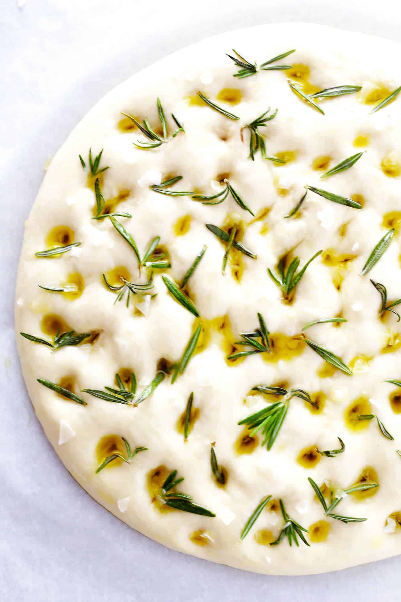 This delicious Rosemary Focaccia Bread recipe is easy to make, and topped with fresh rosemary, olive oil and flaky sea salt. Easy to make as a side for dinner, and it also freezes well! | gimmesomeoven.com #focaccia #bread #italian #side #vegetarian #baking How To Make Focaccia Bread with Rosemary