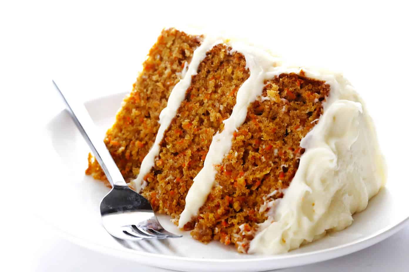 The BEST Carrot Cake Recipe! It's made with an easy homemade carrot cake (no mixer required) and the most heavenly cream cheese frosting. | gimmesomeoven.com #carrot #cake #dessert #easter #creamcheese #frosting #spring #vegetarian Carrot Cake with Cream Cheese Frosting