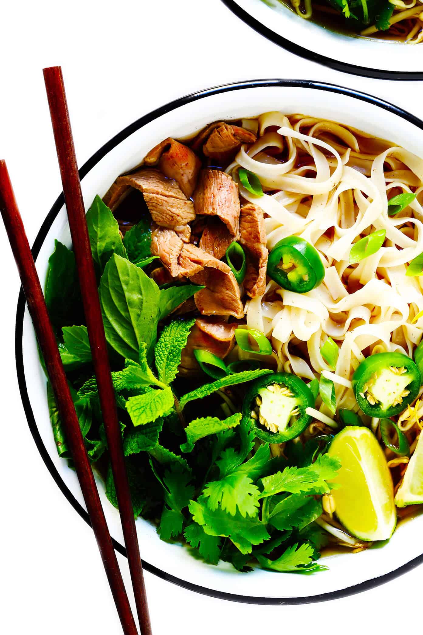 This Vietnamese pho soup recipe is made with the most amazing broth and your choice of beef, chicken, pork or shrimp. Load up your bowls with rice noodles, pile them high with all of your favorite fresh garnishes and enjoy! | gimmesomeoven.com #pho #soup #vietnamese #asian #noodle #healthy #glutenfree #mealprep #dinner Vietnamese Pho Recipe